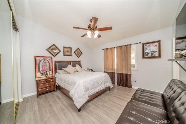 bedroom with a closet, lofted ceiling, ceiling fan, and light hardwood / wood-style floors