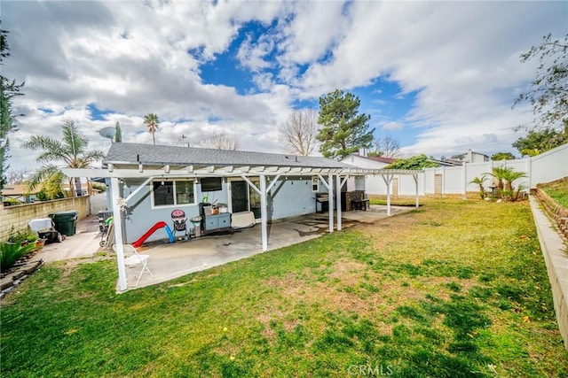 back of house with a pergola, a yard, and a patio