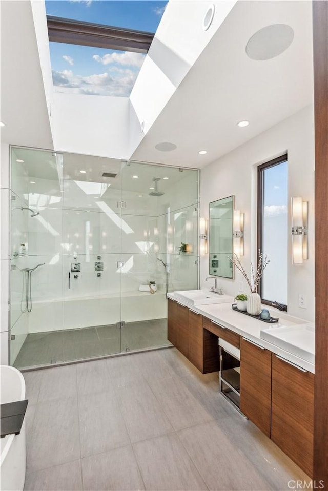 bathroom featuring vanity and a shower with door