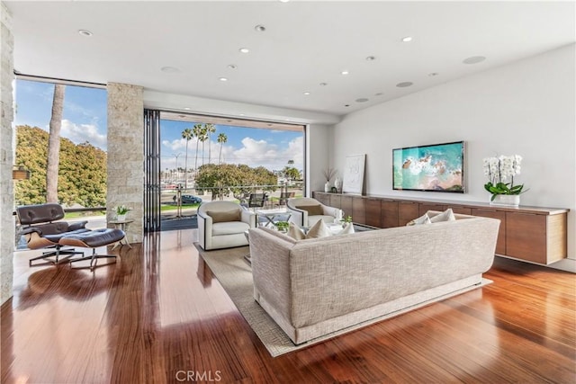 living room featuring hardwood / wood-style floors and a wall of windows