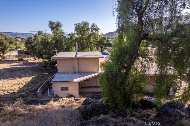 view of side of property with a mountain view