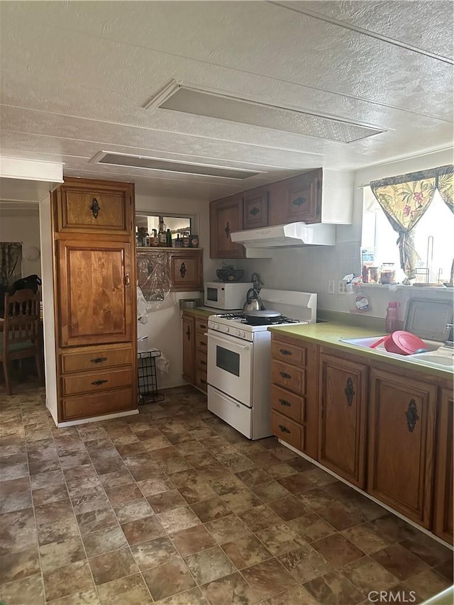 kitchen with white appliances and a textured ceiling