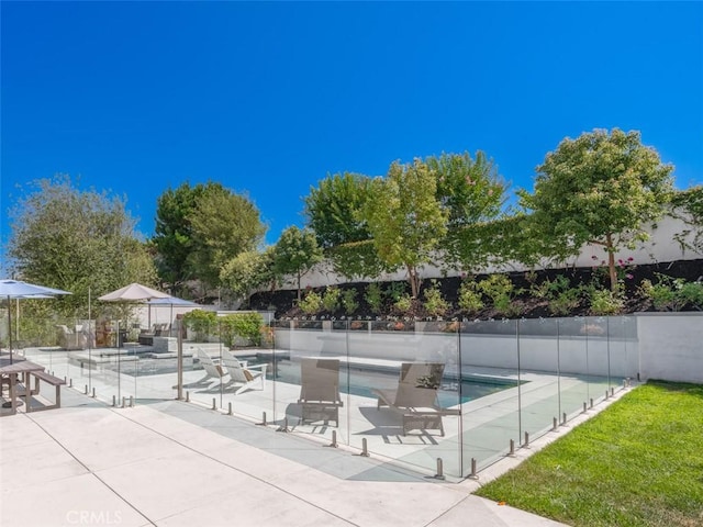 view of property's community featuring a pool and a patio