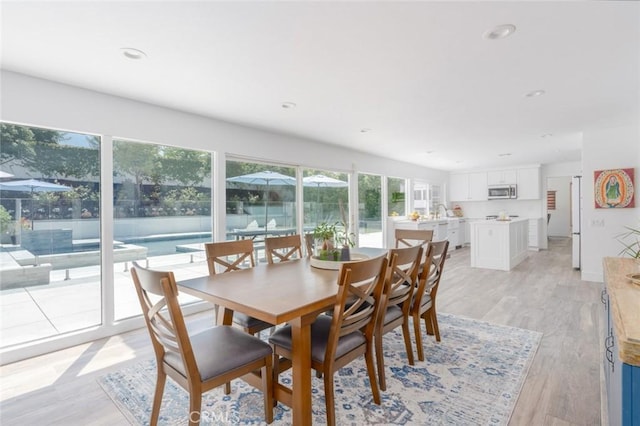 dining area with light hardwood / wood-style flooring