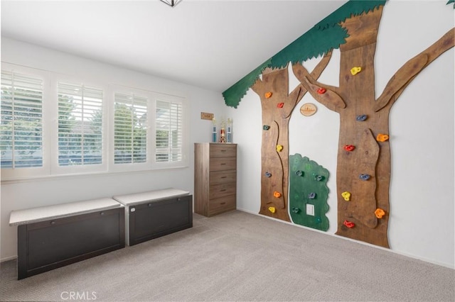 unfurnished bedroom with vaulted ceiling and light carpet