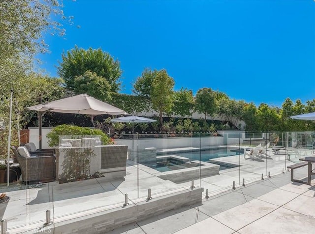 view of pool featuring an in ground hot tub, outdoor lounge area, and a patio area