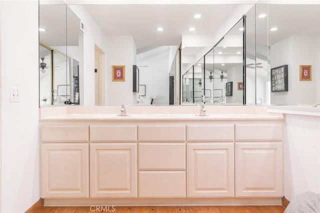 bathroom featuring hardwood / wood-style flooring, vanity, and ceiling fan