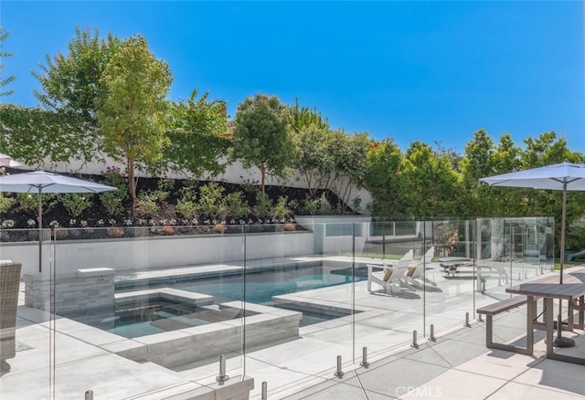 view of swimming pool with an in ground hot tub and a patio