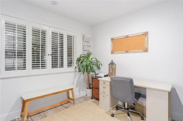 office with light hardwood / wood-style floors