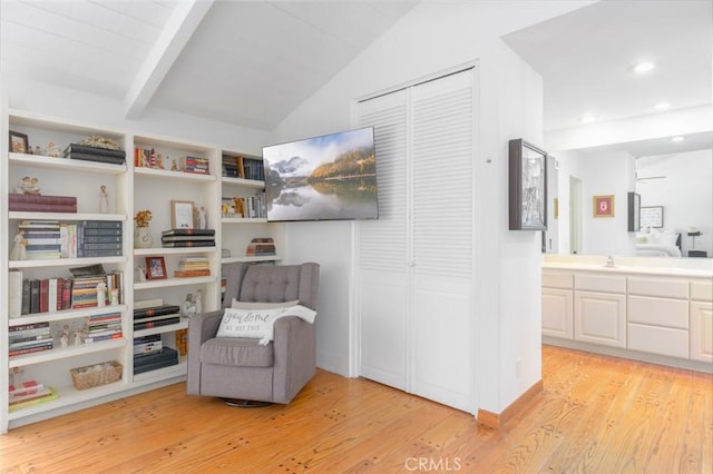 living area featuring wood ceiling, sink, lofted ceiling with beams, and light wood-type flooring