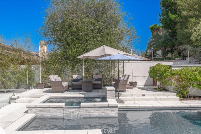 view of patio featuring a pool with hot tub