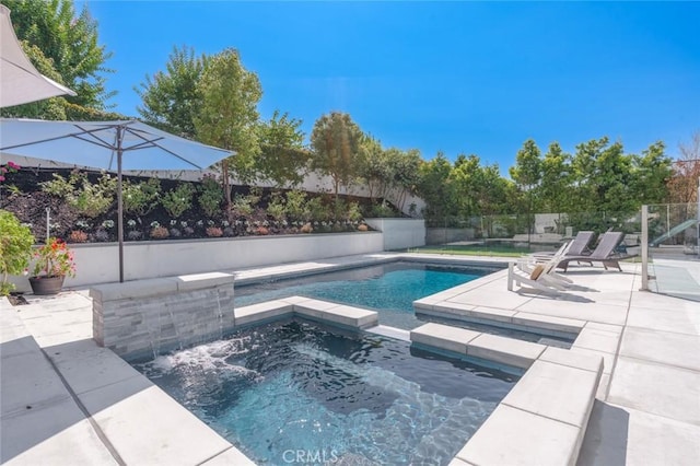 view of pool with a patio area and an in ground hot tub