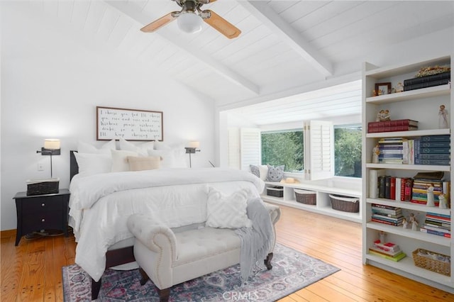 bedroom with hardwood / wood-style floors, lofted ceiling with beams, and ceiling fan