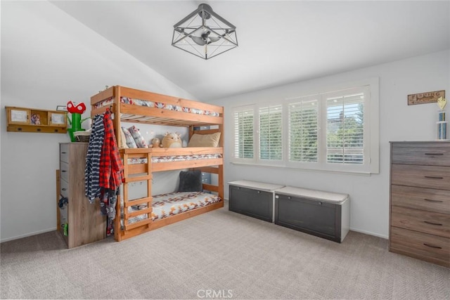 carpeted bedroom featuring vaulted ceiling