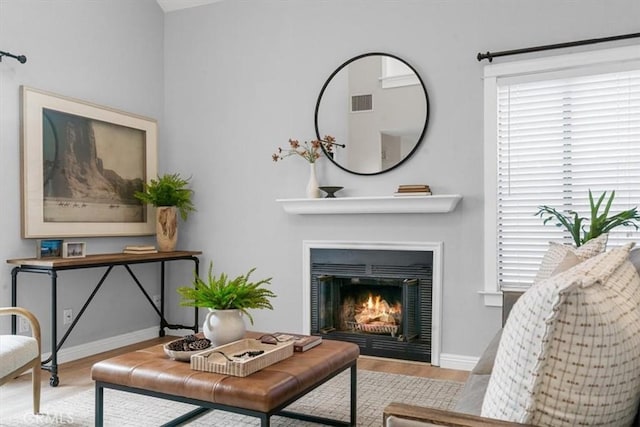 living area featuring a wealth of natural light and light hardwood / wood-style floors