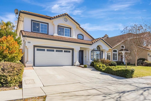 mediterranean / spanish home with a garage