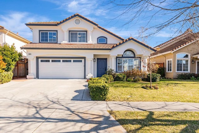 mediterranean / spanish house with a garage and a front yard