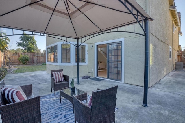 view of patio / terrace with a gazebo, outdoor lounge area, and central air condition unit