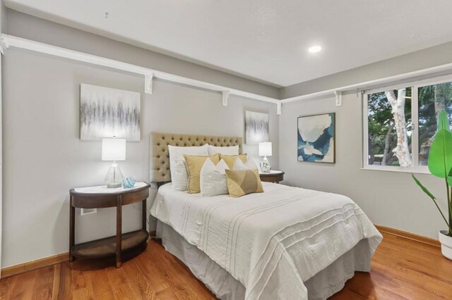 bedroom with hardwood / wood-style floors