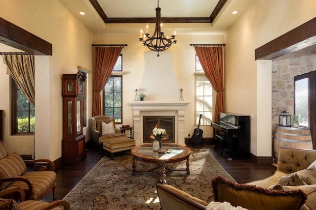 sitting room with crown molding, a towering ceiling, a chandelier, and dark hardwood / wood-style flooring