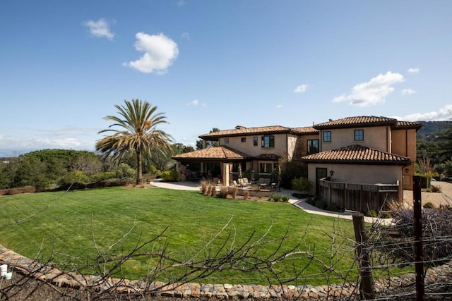 back of property with a patio and a lawn