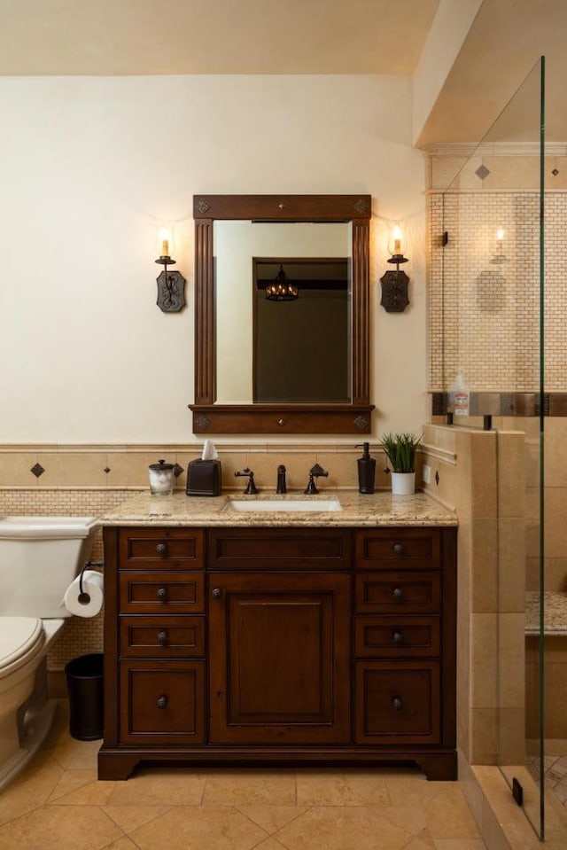 bathroom with tile patterned flooring, vanity, walk in shower, and toilet