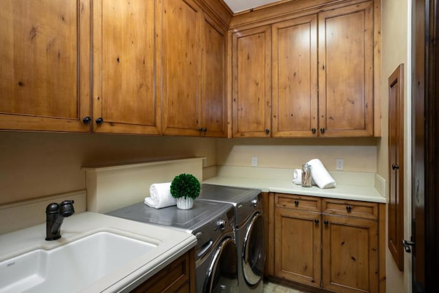 laundry area featuring cabinets, sink, and washing machine and dryer