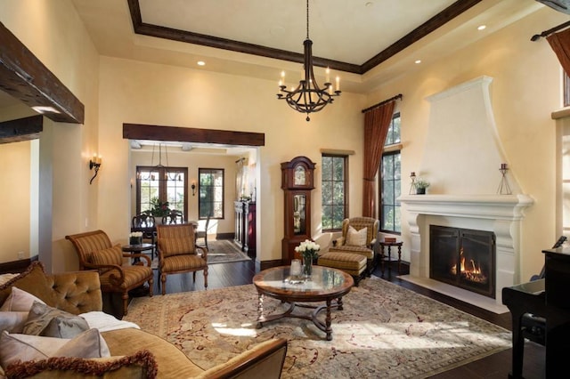 living room with ornamental molding, dark hardwood / wood-style floors, and a chandelier