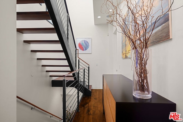 stairway featuring wood-type flooring