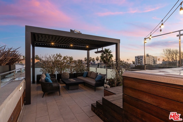 patio terrace at dusk featuring outdoor lounge area