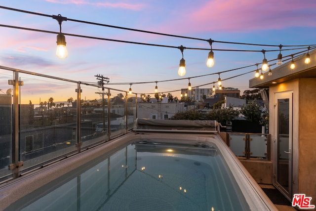 view of pool at dusk