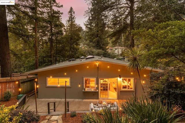 view of back house at dusk