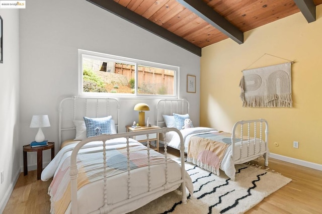 bedroom featuring lofted ceiling with beams, wood ceiling, and light hardwood / wood-style floors