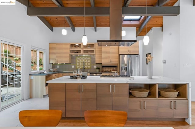 kitchen featuring appliances with stainless steel finishes, decorative backsplash, hanging light fixtures, a center island, and wood ceiling