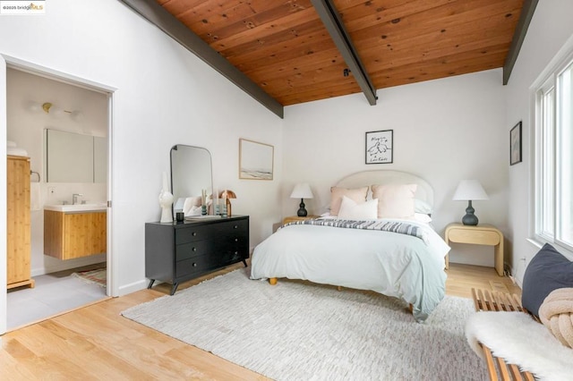 bedroom with wood ceiling, ensuite bath, multiple windows, and light hardwood / wood-style flooring