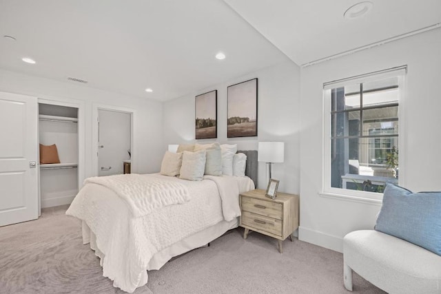 bedroom with multiple windows and light colored carpet