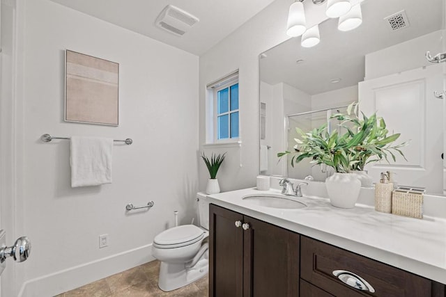 bathroom featuring a shower with door, vanity, and toilet