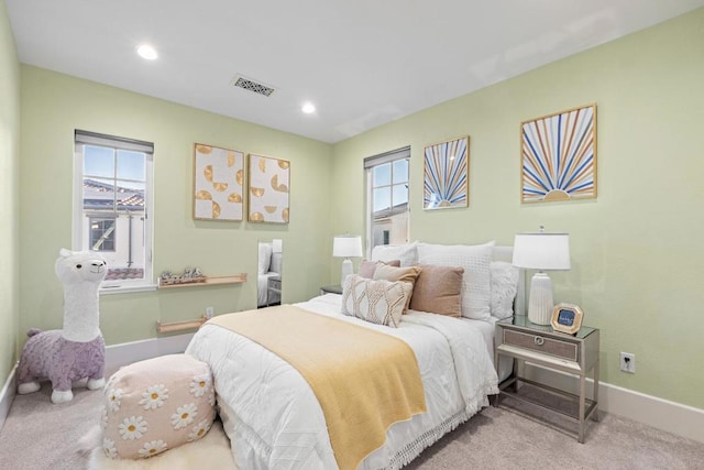 bedroom featuring light colored carpet