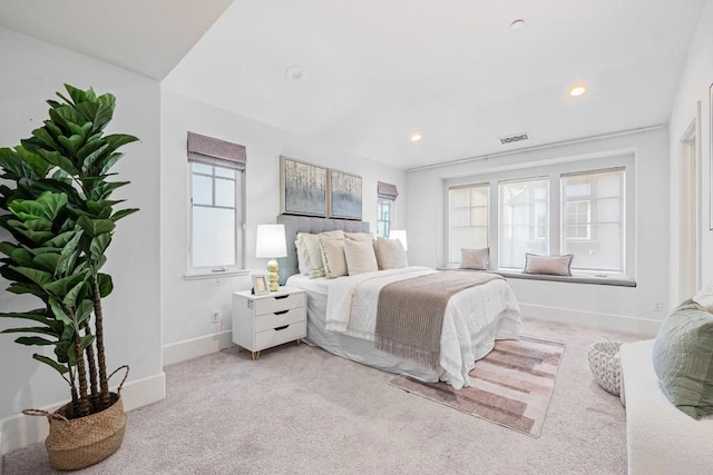 carpeted bedroom featuring multiple windows