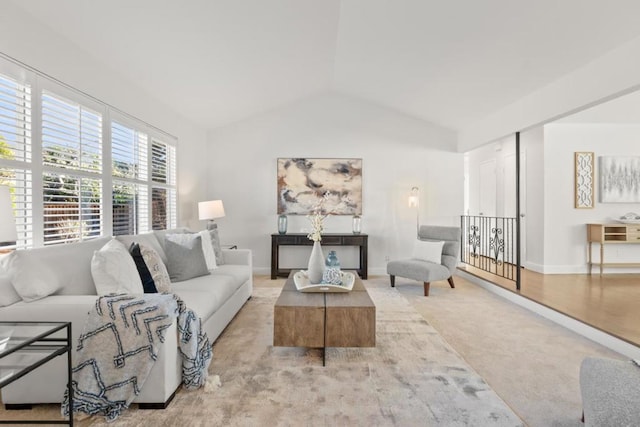 carpeted living room featuring lofted ceiling