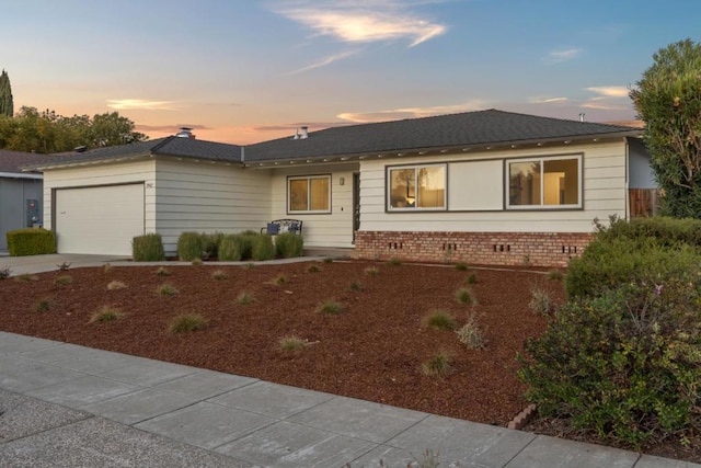 ranch-style home featuring a garage