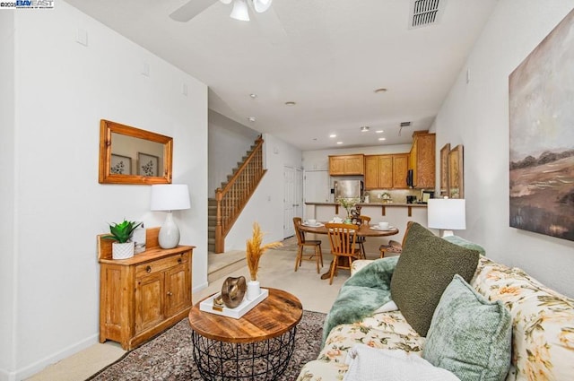 carpeted living room featuring ceiling fan