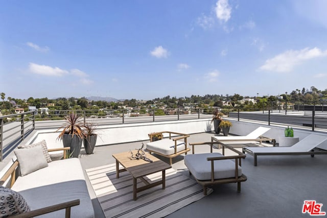 view of patio featuring a balcony and an outdoor living space