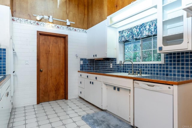 kitchen featuring tasteful backsplash, white cabinetry, sink, tile counters, and white dishwasher