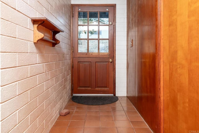 doorway with light tile patterned floors