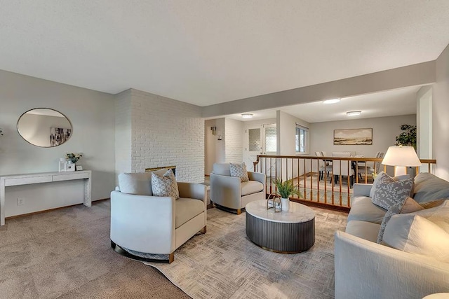 carpeted living room featuring a large fireplace