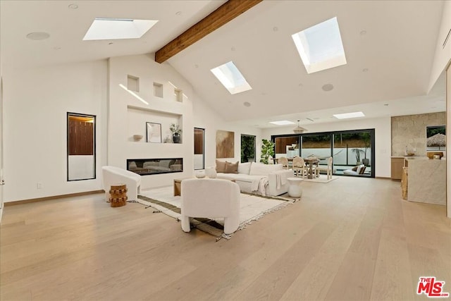 living room featuring beam ceiling, light hardwood / wood-style floors, and high vaulted ceiling