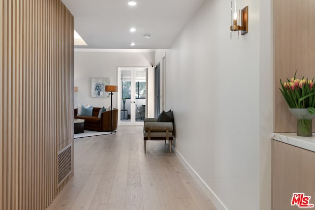 corridor featuring french doors and light wood-type flooring