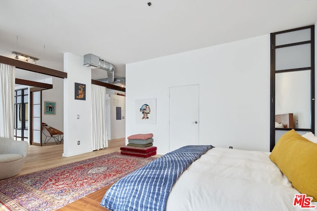 bedroom with hardwood / wood-style flooring