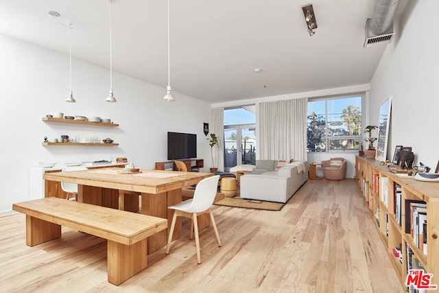 dining area with light hardwood / wood-style floors